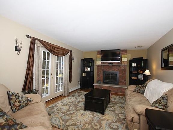 Spaceous Living room with wood fireplace : Wood flooring with plenty of room for seating.