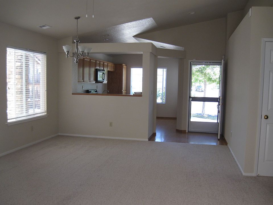 Living room, dining room area, with kitchen in background.
