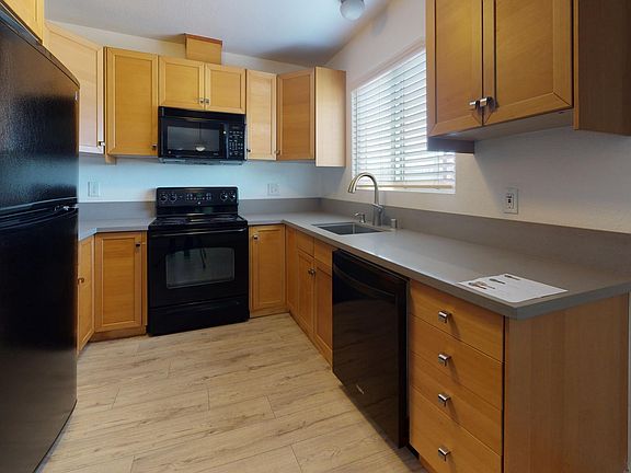 Updated kitchen with new dishwasher, new appliances, built-in microwave, and solid surface counters.