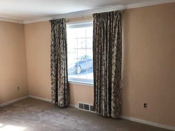 Living Room front window with brand new wall to wall carpeting.