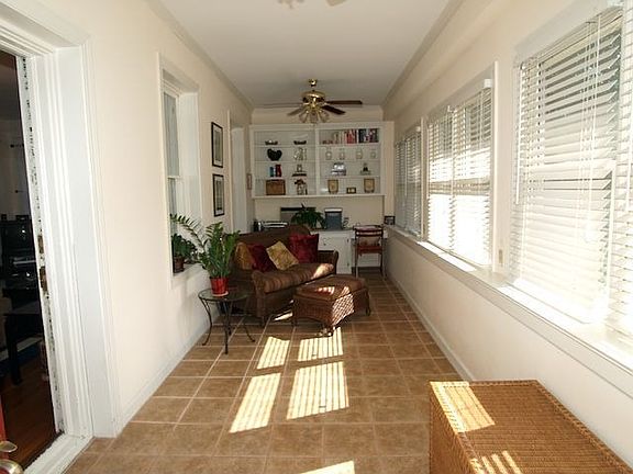 View from the ft door to the Florida/sun room w/ built in shelves & cabinets