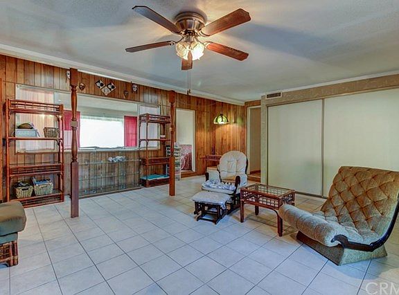 Enclosed patio room with hallway just to left of closets to back bedroom and laundry room. Family room on other side of window to left. 