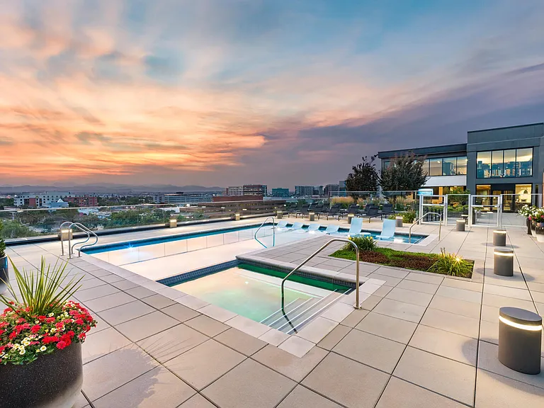 Rooftop pool and spa with sunset views over the city and mountains.