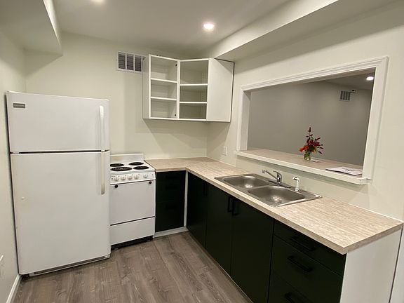 Kitchen (upper cabinets also have green fronts; prior tenant had us take them off for open shelving)