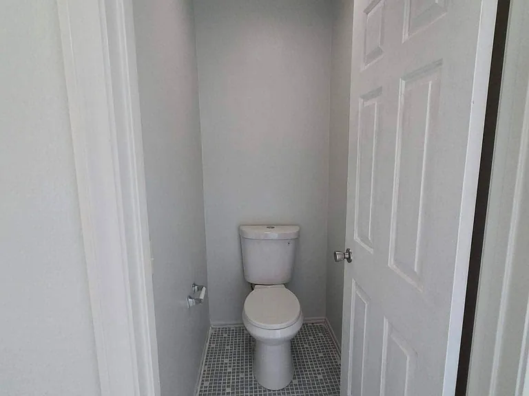 Private water closet within the spacious primary bathroom.