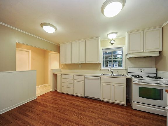 White eat-in kitchen with garden window 