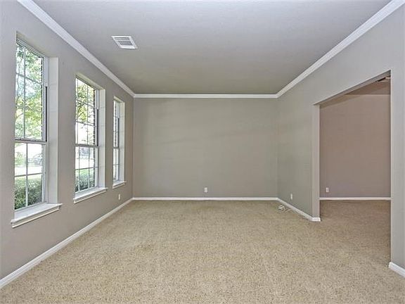 The second living open to family room is lined with windows.