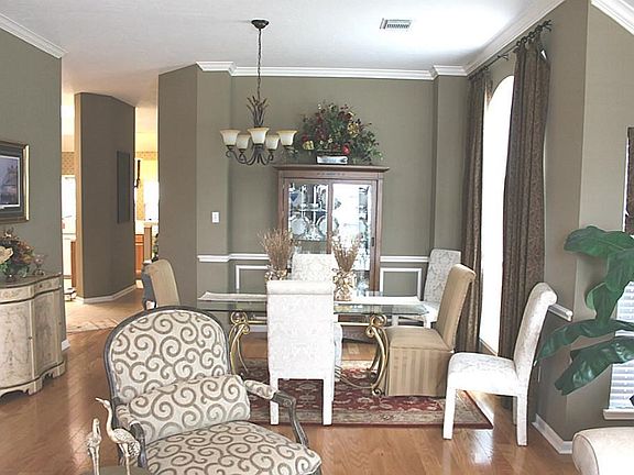 View of dining room from the living room. High ceilings with crown molding. Large window for natural lighting. Chair molding throughout the dining room.