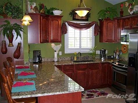 Conversation is complementary to any meal and this open, fully equipped kitchen with counter bar provides for lots of conversation! Entertaining or dining for 1, 2, 3, 4, or more? This exquisite kitchen flowing into the dining room, to the right of the counter, allows the chef of the house to enteract with dining companions! Love to cook? This wonderfully appointed kitchen boasts granite countertops, amazing wood cabinets with crown molding, contemporary nickel hardware, Stainless Appliances, cathedral/vaulted ceiling, ceramic tile flooring, Chandelier lighting, Lg window with Plantation Shutters & more!