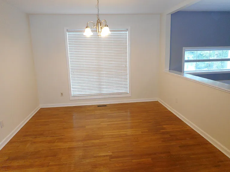 Spacious formal dining room with polish hardwood floor with