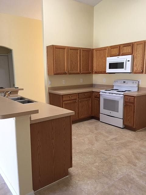 Kitchen with new stove and microwave