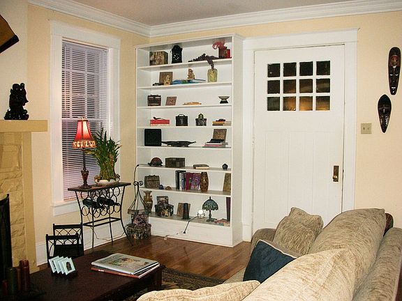 Front door of living room leads to glassed in porch