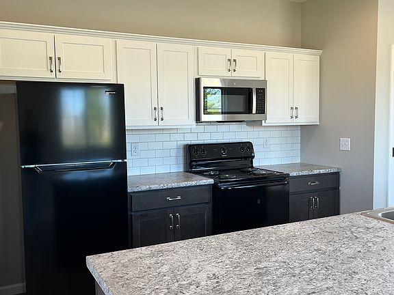 Kitchen is complete with Electric Range, Space-saver Microwave, Refrigerator and Dishwasher