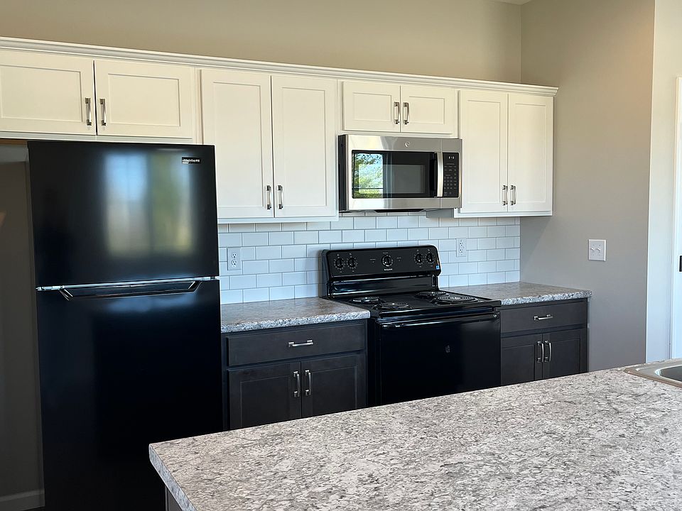 Kitchen is complete with Electric Range, Space-saver Microwave, Refrigerator and Dishwasher