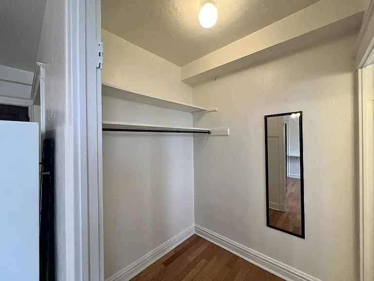 Dressing room offers more storage space, full-length mirror and electric outlet.