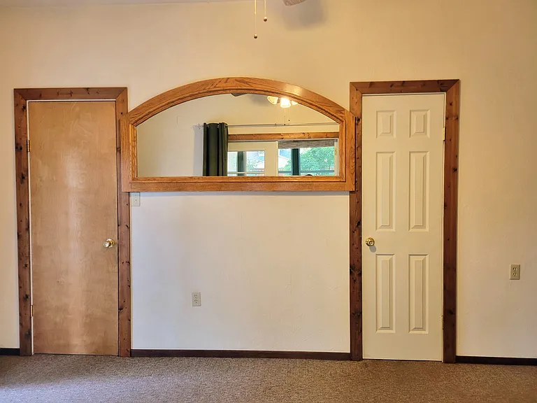 Secondary room with with large walk-in close to the left and full bathroom on the right