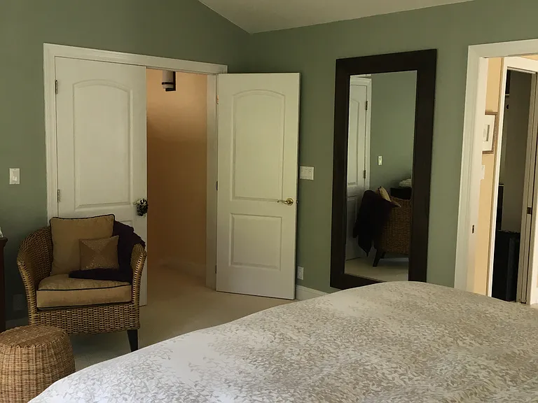 Primary Bedroom with multi-speed fan. Attached full length mirror.