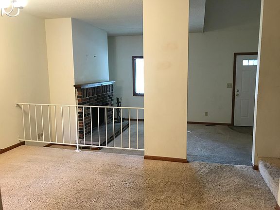 From kitchen through dining room to sunken living room with wood burning fireplace