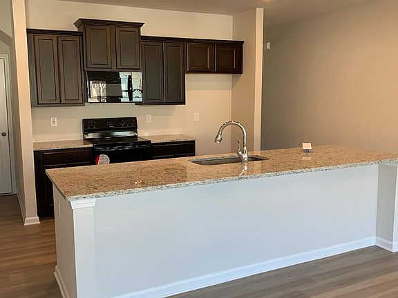 Kitchen with granite countertop and large island