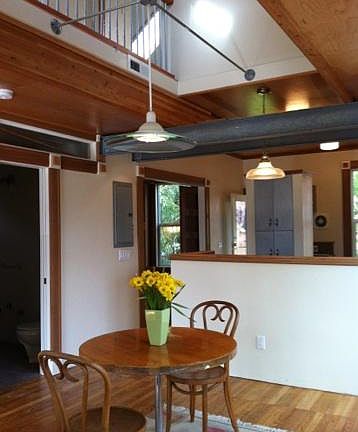 View of dining room into kitchen and second story bridge