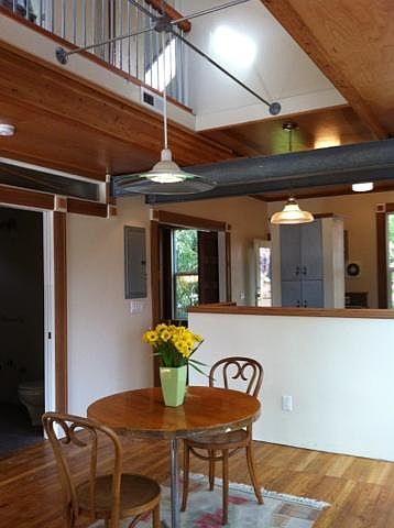 View of dining room into kitchen and second story bridge