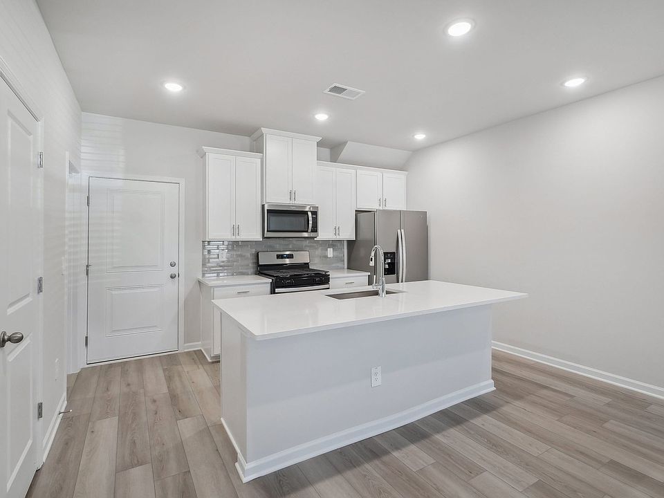A sizeable kitchen island overlooks the sprawling great room.