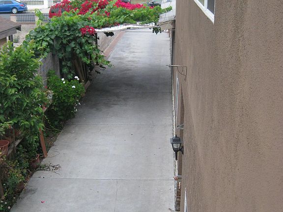 Side view of building. Long Driveway. Apt in rear upstairs