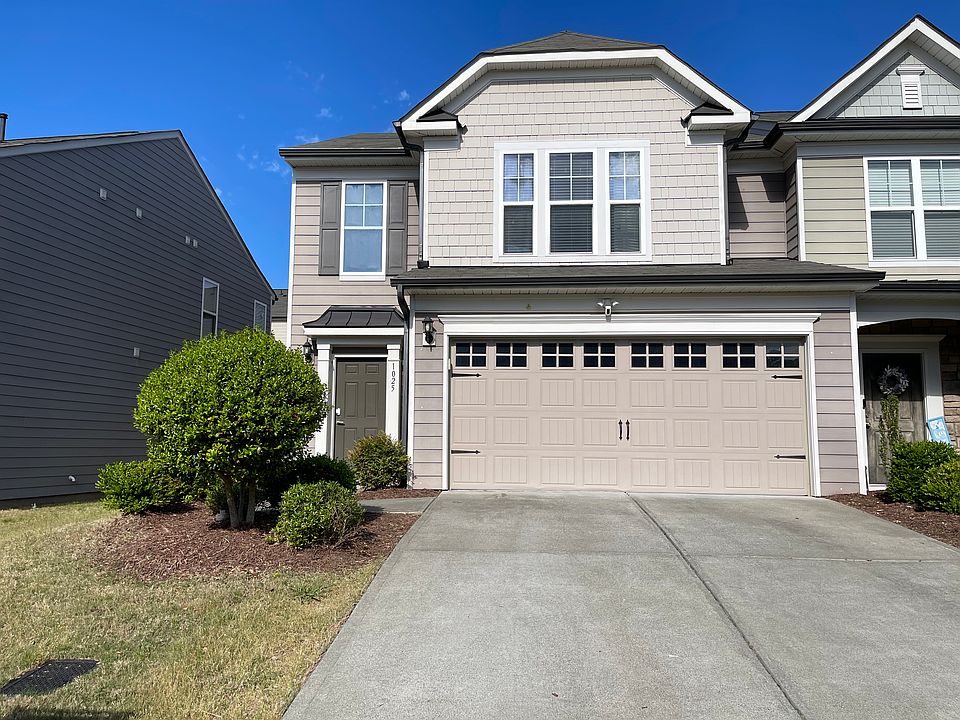 Front exterior of end-unit townhouse with attached two-car garage