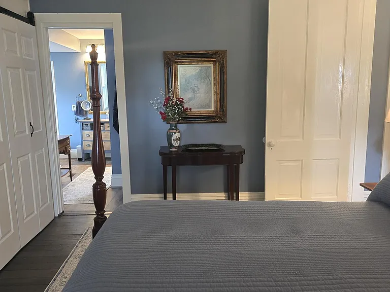 View from front window of primary bedroom to master bath suite (pocket door on left)