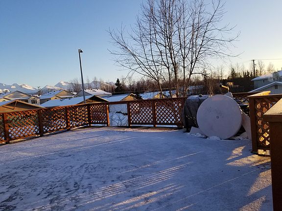 Deck with South East view of Chugach Mountains, picnic table, Barbeque grill (covered).