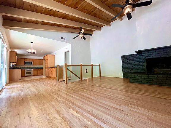 Upstairs informal living room and fireplace open to the kitchen