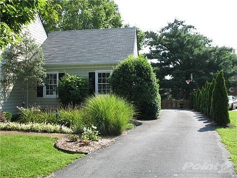 All new landscaping including trees along the long driveway and shrubbery and flowers in front.