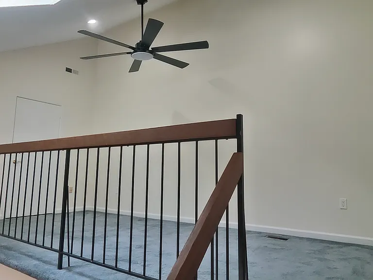 Loft area with a separate ceiling fan, recessed lights and sky lights