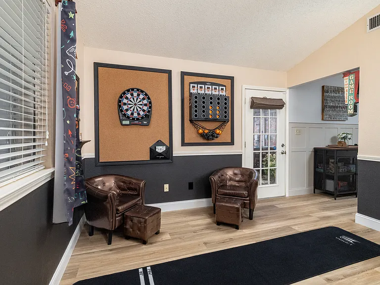 Game Room with Basketball game, mechanical dart board, Ms. Pac Man arcade game, board games, puzzles, and Foosball