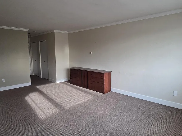 Large sunny living area with remote-controlled air conditioner.
