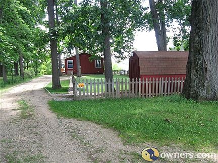 Fenced back yard with shed.