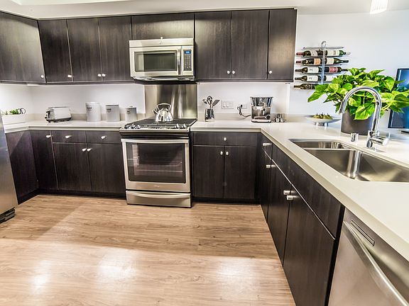 High-end stainless steel appliances and custom cabinets highlight our kitchens