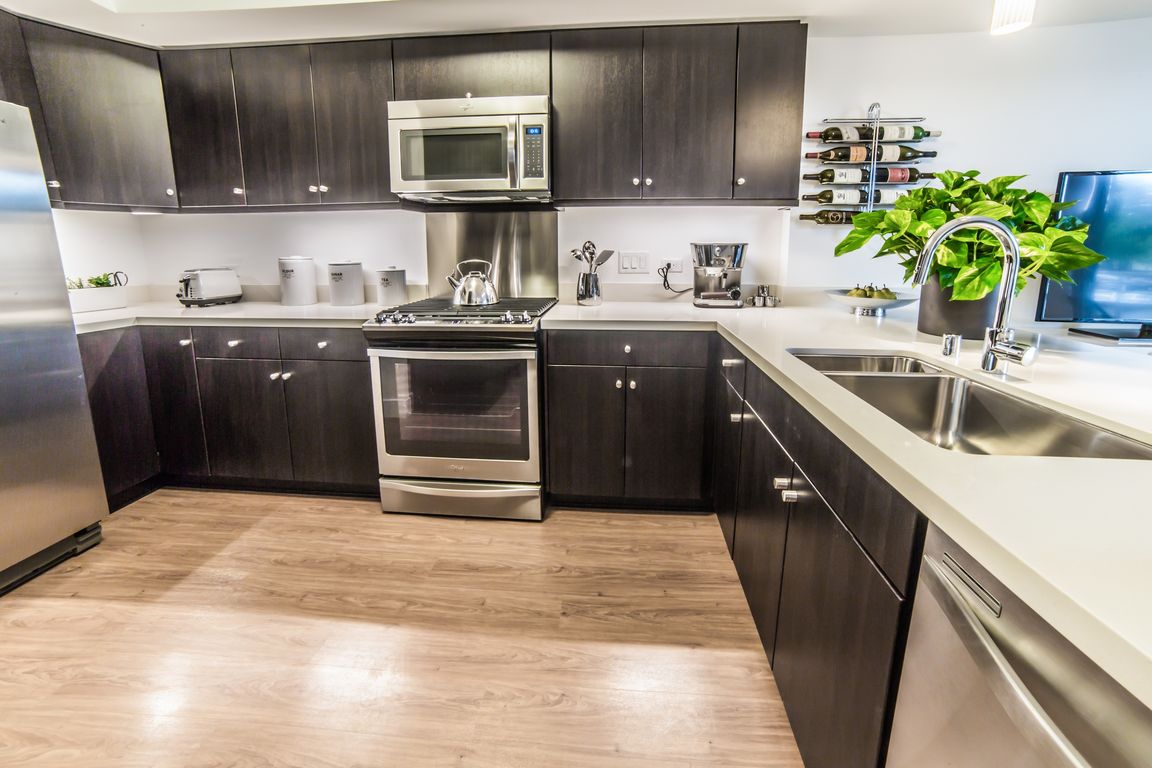 High-end stainless steel appliances and custom cabinets highlight our kitchens