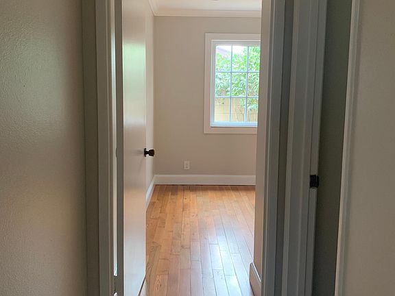 Hallway to downstairs 1/2 bath and office/den