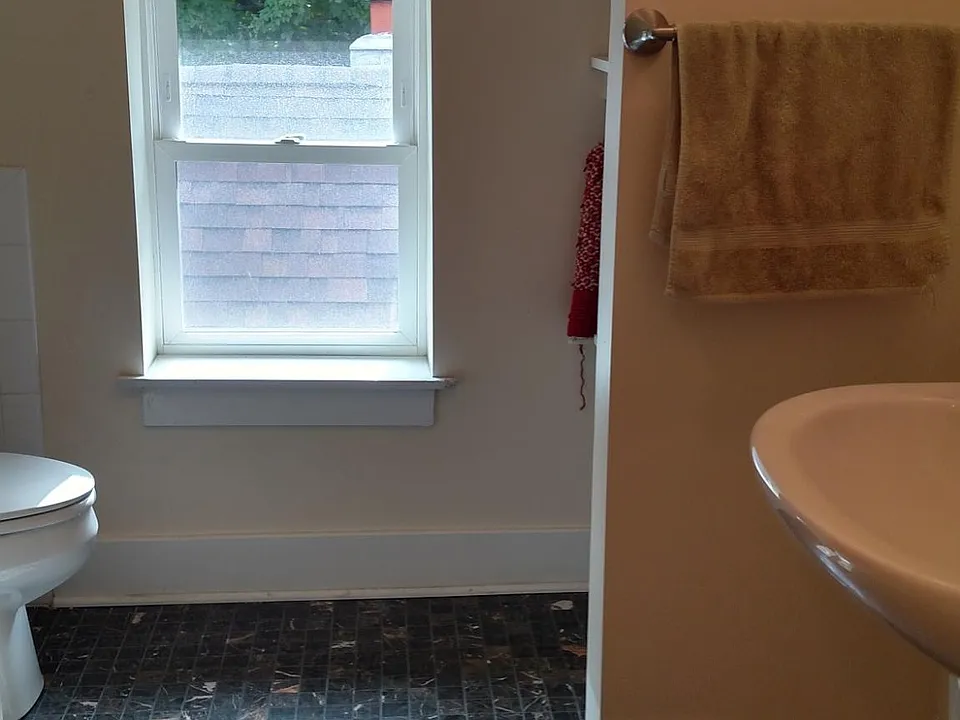 Bathroom is a nice size with some storage.