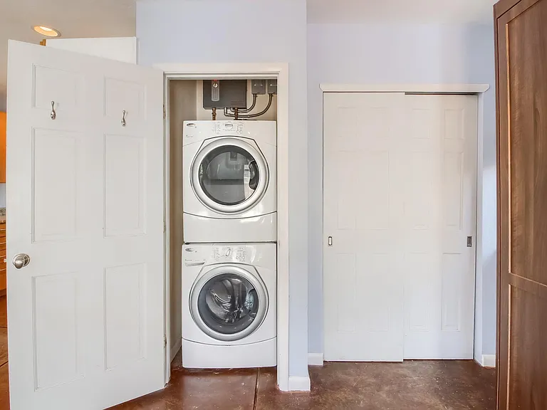 Washer/dryer and electric hot water heater. Closet to the right.