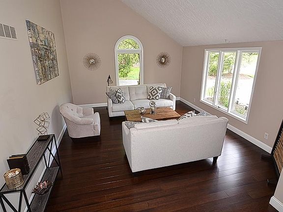 Light and bright formal living room has beautiful view of the large front yard and landscaping