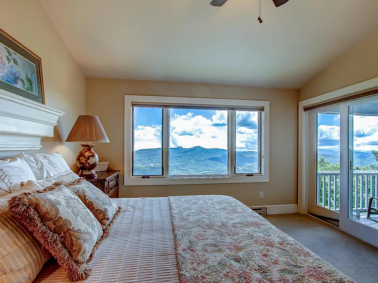 Primary bedroom has window with views and access to the covered deck plus a ceiling fan and recently updated ensuite bath.