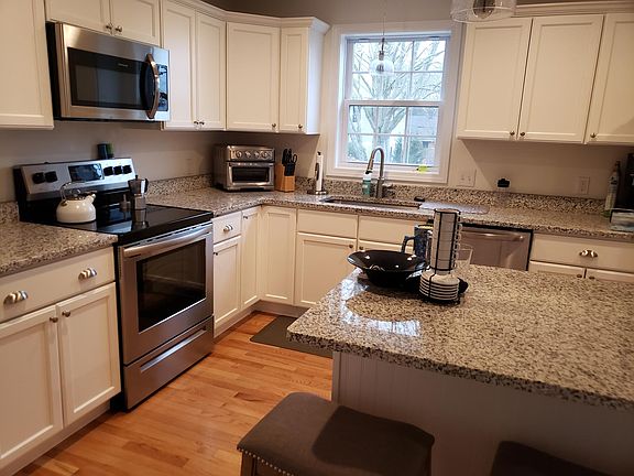 Barstool seating for 3, New appliances (electric range stove, dishwasher, microwave, fridge)