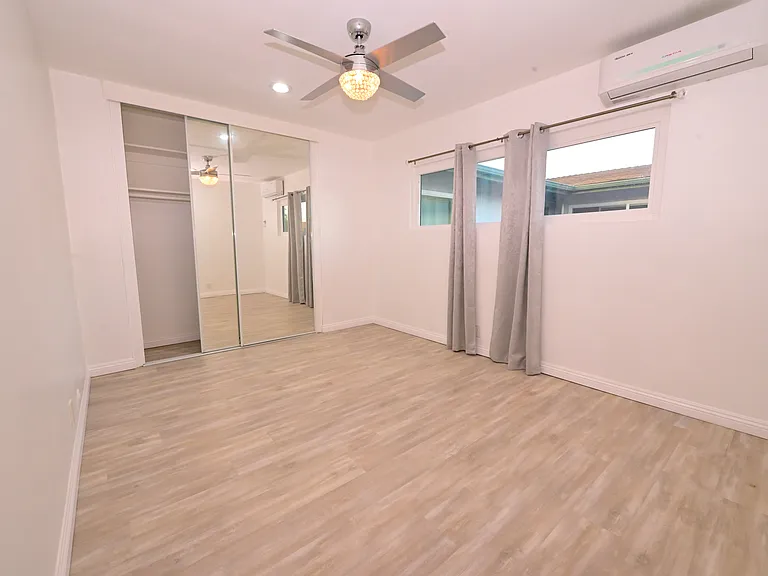 spacious master bedroom with A/C and ceiling fans