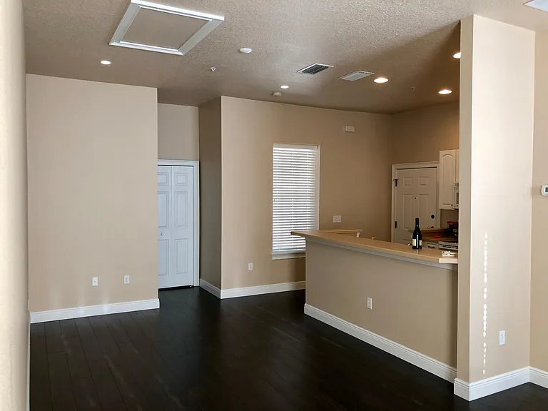 Space for a love seat, tabletop entertainment center, tv, rug and coffee table. Main area lighting is all recessed on a dimmer. Kitchen also has recessed lighting.