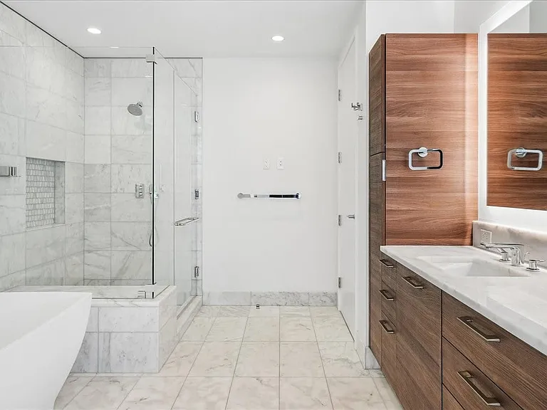 Spacious en suite primary bath with soaking tub and oversized walk-in shower