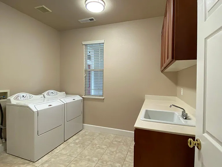 Large laundry room with plenty of storage. Washer/dryer included. Appliances different than shown in photo.