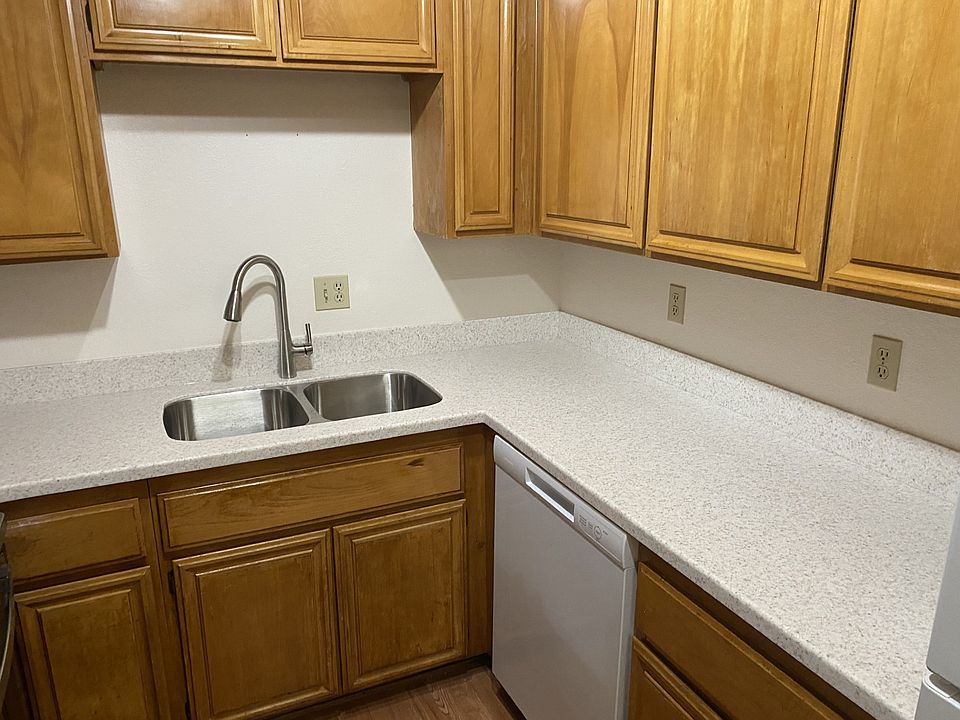chefs kichen with stone counter tops, new sink and dishwasher