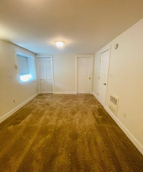 large bedroom - has access to living room and on-suite bathroom, and utility closet